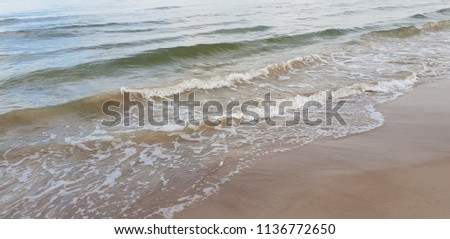 Baltic Sea beach with water, sand and sky. 