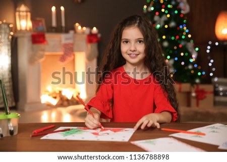 Little child drawing picture at home. Christmas celebration