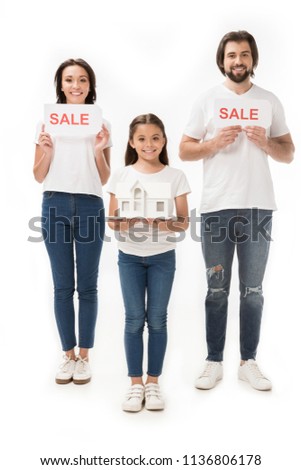 smiling family with sale cards and house model isolated on white