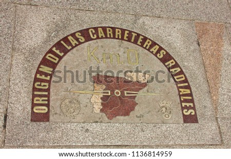 Kilometer Zero tile in the downtown of Madrid. Sidewalk of Sol Square in front of the post office building (with it famous clock), Madrid (Spain).