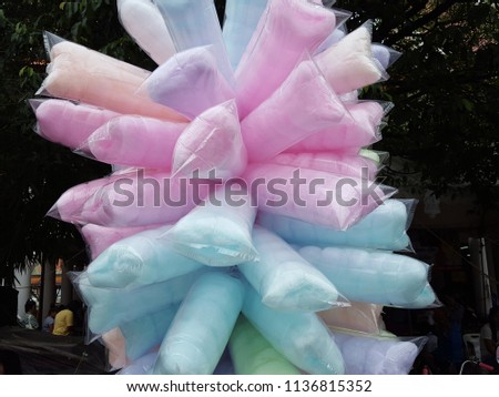 Candy floss in plastic bag containing. cotton candy in rainbow colours. Soft focus,Select focus Royalty-Free Stock Photo #1136815352