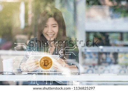 Closeup Asian businesswoman hand using technology tablet with Bitcoins mockup over the Abstract photo of FINTECH connection hologram in workplace co-working space,blockchain and bitcoin concept