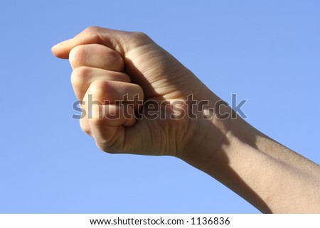  A hand motioning grasping action against the clear blue sky - with Clipping Path