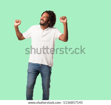Handsome african american Listening to music, dancing and having fun, moving, shouting and expressing happiness, freedom concept