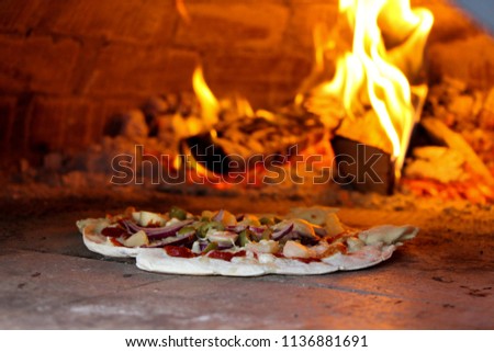 Pizza in a outdoor brick oven