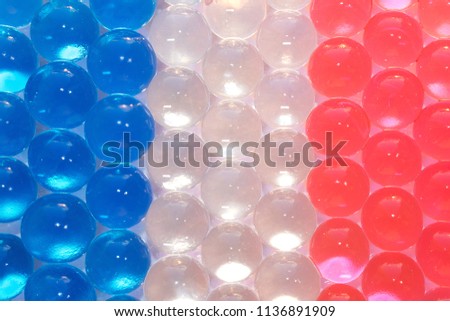 Colorful gel balls symbolizing the French flag. Hydrogel. Macro