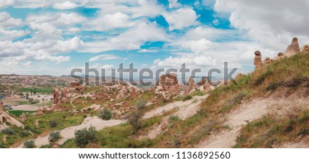 Panoramic view of Fairy Chimneys with beautiful old rock formations in Cappadocia, Goreme, Nevsehir, Turkey. Holiday, travel and vacation in Cappadocia Turkey.