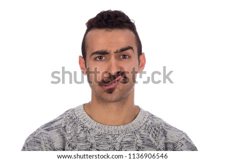 Funny picture of a serious looking man with mustache, sucking his cheeks, looking to the camera, isolated in a white background.
