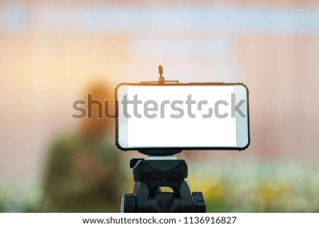 LCD Screen Blank smartphone on Tripod for copy space in your text message or promotional content, advertising mock up empty insert for coutomer Background.