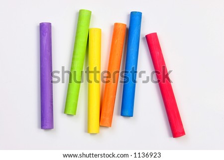 Colored chalks over a white background.