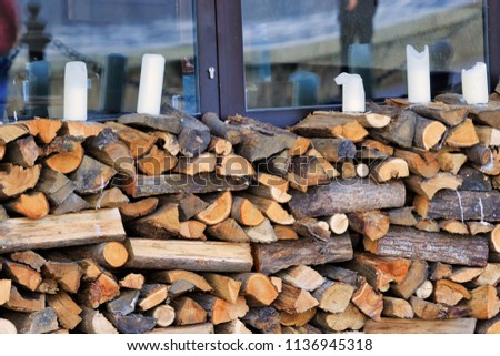 Firewood with candles resting on top