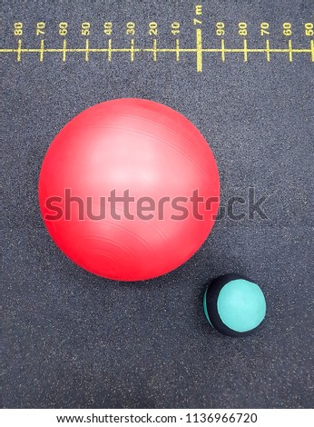 Sports equipment. Exercise ball on grey floor