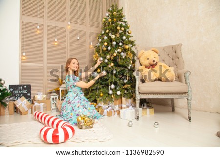 pretty young girl have fun and happy in her Christmas decorated room