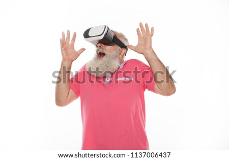 Old bearded man using VR glasses doing surprise gesture