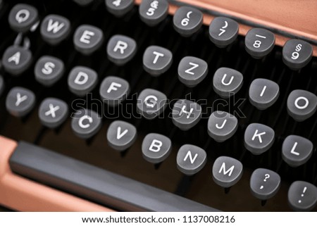 Stylish black keyboard of a retro typewriter in the studio. Closeup horizontal photo.