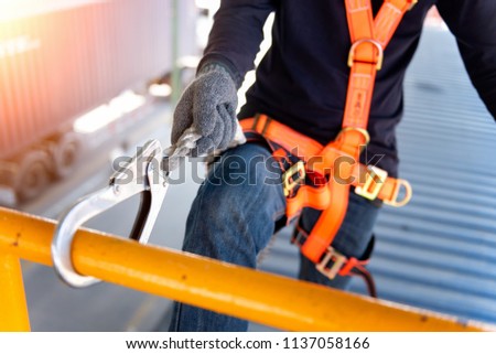 Construction worker use safety harness and safety line working on a new construction site project.Harness is a equipment for safety in construction site. Royalty-Free Stock Photo #1137058166
