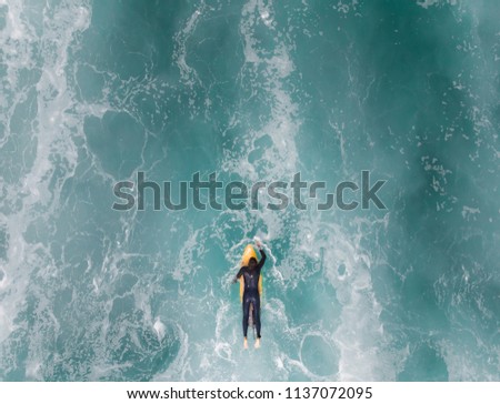 French surfer trying to catch a wave