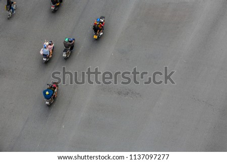 Blur motion people on motorcycles are moving on road, Aerial top view shot, selective focus at road.