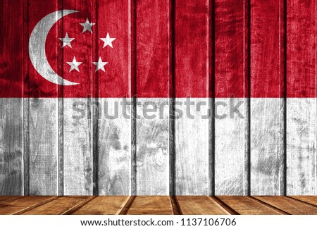 Wooden background with a flag of Singapore.