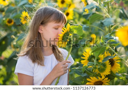 The girl in the field of sunflowers