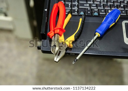 technical tool set computer upgrade repair screwdriver cutting pliers on keyboard background design