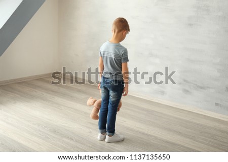 Little boy in empty room. Autism concept