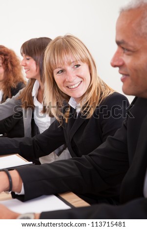 Portrait Of Young Business Woman In Meeting With Colleagues