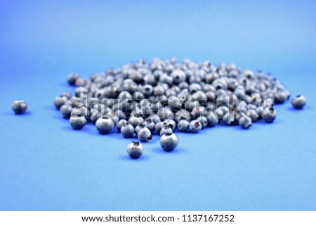 Blueberries stock images. Blueberries on a blue background. Healthy summer fruit