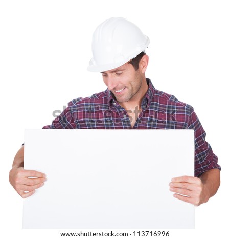 Man Wearing Hard Hat Holding Placard On White Background