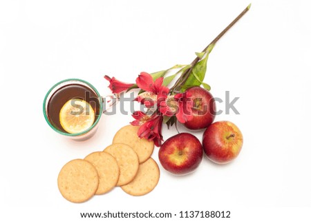 Top view of digestive biscuits, tea, apple and flower on a white background. Still life photography, waiting for autumn and Fall Harvest. Nice warm colors and nostalgic mood.