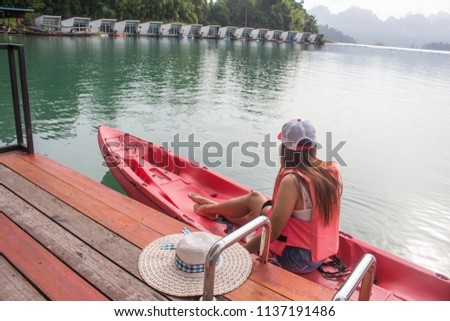 Girl getting kayak Relaxing on dam.
