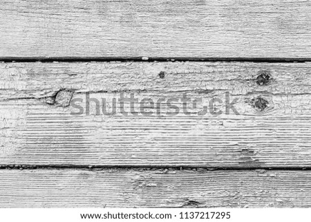 Monochrome texture of a board with peeling paint. Abstract background for design.