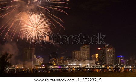 Fourth of July 2018 Fireworks show in New Orleans, LA with the city skyline in the background across the Mississippi River.