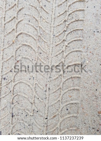 car traces on wet soil, photo close up, photo abstract background