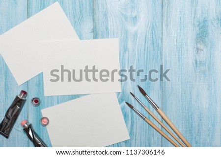 blank for creativity, drawing. a top view of the working artisans on a blue wooden background. flat lay