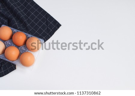 Raw Eggs and checkered black napkin Minimal Picture White Background Kitchen Supplement Copy Space Preparation Cooking Baking Kitchen Table Top view