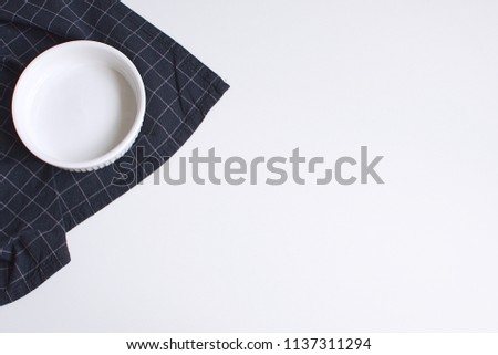 White baking mold and checkered black napkin Minimal Picture White Background Kitchen Supplement Copy Space Preparation Cooking Baking Kitchen Table Top view