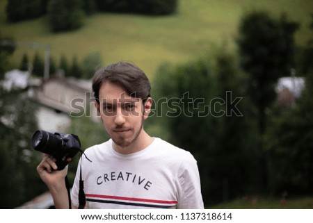 portrait of a man holding camera