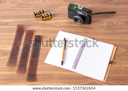 Checking the images of my analog camera, next to my notes