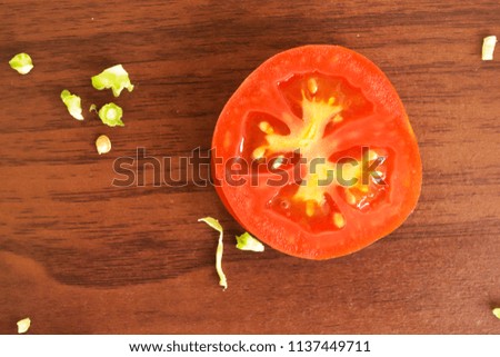 Sliced tomato on the wooden background royalty free stock images