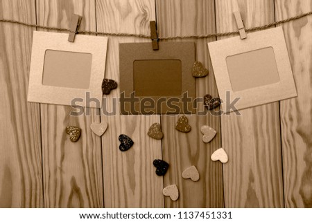 Empty paper with clip hang on rope isolated on wooden background for your text and advertising.Sepia tone.