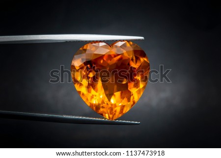 madeira citrine gemstone.The color of Madeira golden-orange to reddish-brown.Dark, pretty big expensive.heart-shaped
 Royalty-Free Stock Photo #1137473918