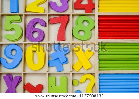Wooden alphabet blocks with letters and numbers.Random wooden typeset letterpress background.Multi color.