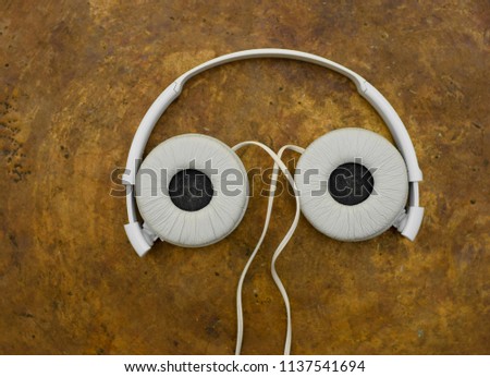 headphone looking like eyes on copper plate