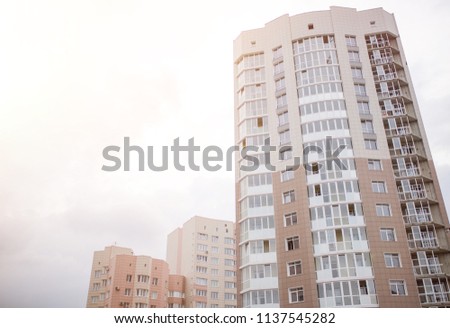 Newly constructed buildings above the transparent, cloudless blue sky.
Multi-family houses, isolated on white background.