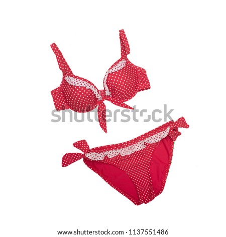 Red polka dots swimsuit on a white background. Isolate. Beach wardrobe. Fashionable concept