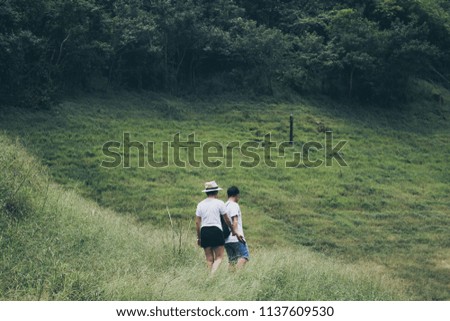 Asian young couple man and woman traveler take a photo travel and hiking , relax at the peak mountain or green forest