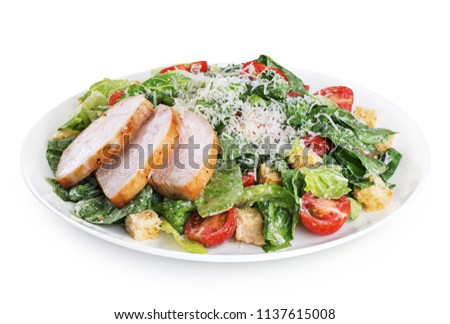 Caesar salad with chicken fillet and parmesan cheese isolated on white background. With clipping path.
