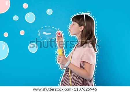 Soap bubbles. Calm cute teenage girl blowing soap bubbles and relaxing