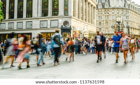 Busy crowds of anonymous motion blurred shoppers on London street Royalty-Free Stock Photo #1137631598